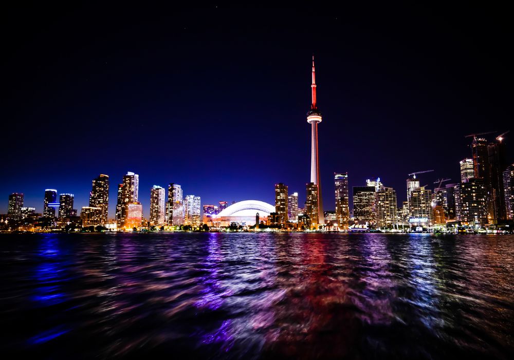 Toronto skyline lit up at night with CN Tower – Canada Tour Package From India