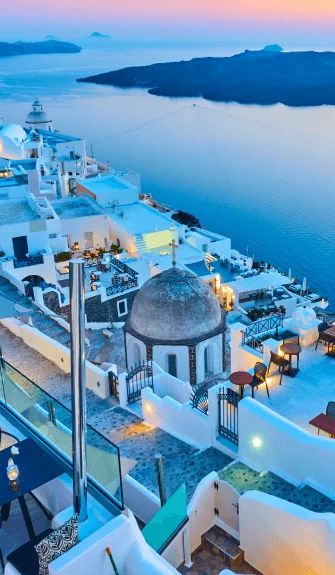 Scenic view of Santorini’s white buildings and blue sea – Fab Holidays, the best travel agency in Delhi.