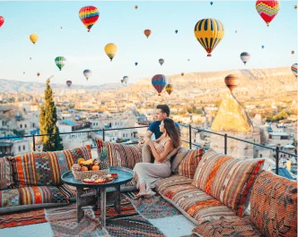 Couple enjoying hot air balloon view on a luxury rooftop trip organized by best travel agency in Delhi