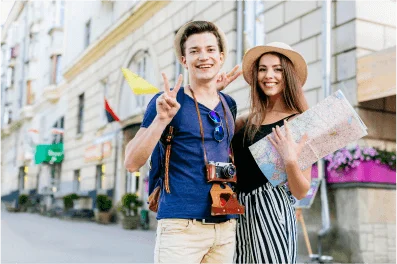 Young couple sightseeing with map and camera booked via best travel agency in Delhi