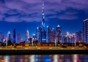Night view of Dubai skyline with Burj Khalifa, featured in a Dubai tour package by Fab Holidays