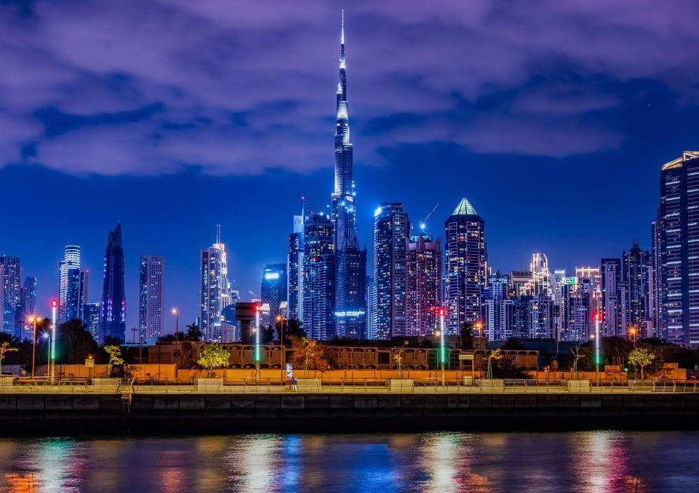 Night view of Dubai skyline with Burj Khalifa, featured in a Dubai tour package by Fab Holidays