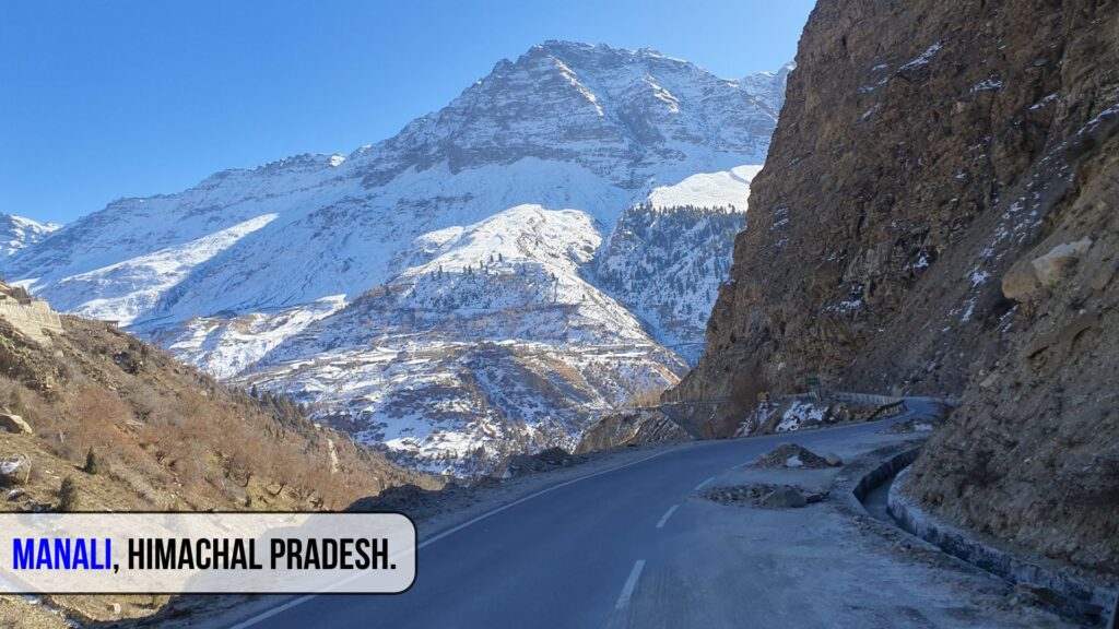 Scenic view of snow-covered mountains and winding roads in Manali, Himachal Pradesh – one of the best places to visit in India during summer