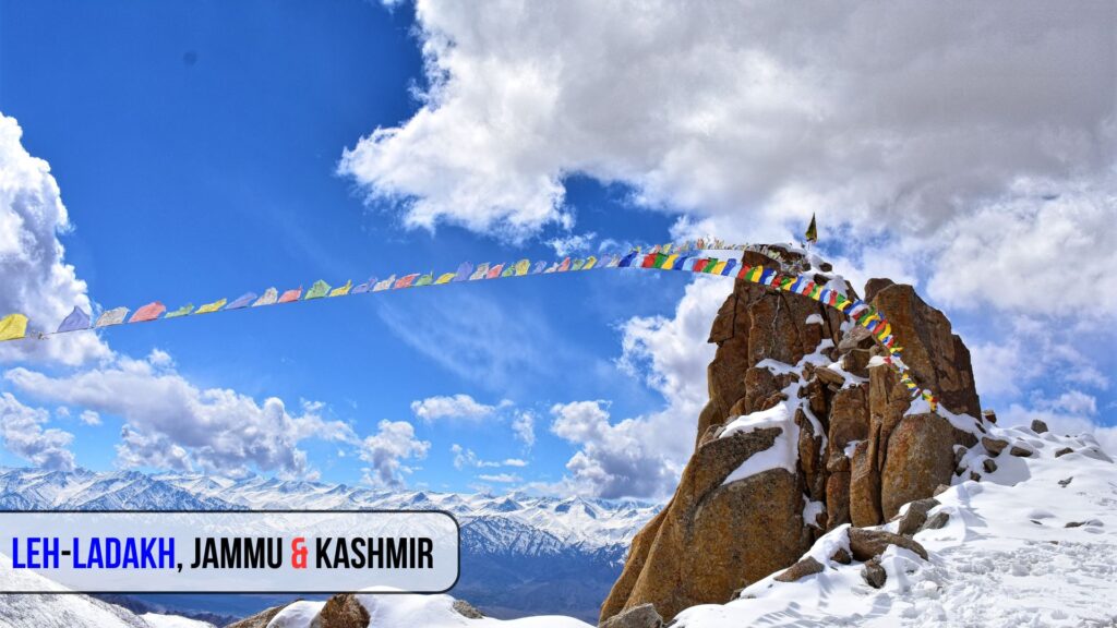 Snow-covered mountains and colorful prayer flags in Leh-Ladakh, Jammu & Kashmir – one of the best places to visit in India during summer