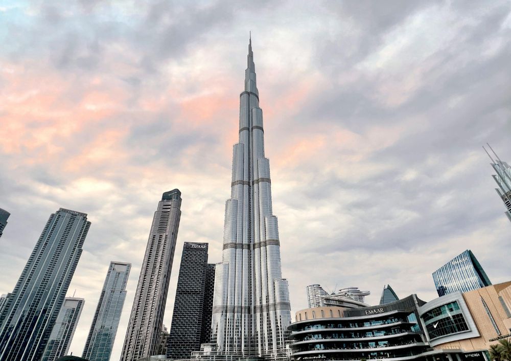 Burj Khalifa during sunset with surrounding skyscrapers, featured in a Dubai tour package by Fab Holidays