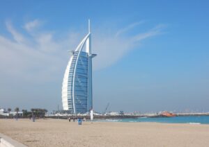 Burj Al Arab hotel with beach view under blue sky, included in Dubai city tour package by Fab Holidays