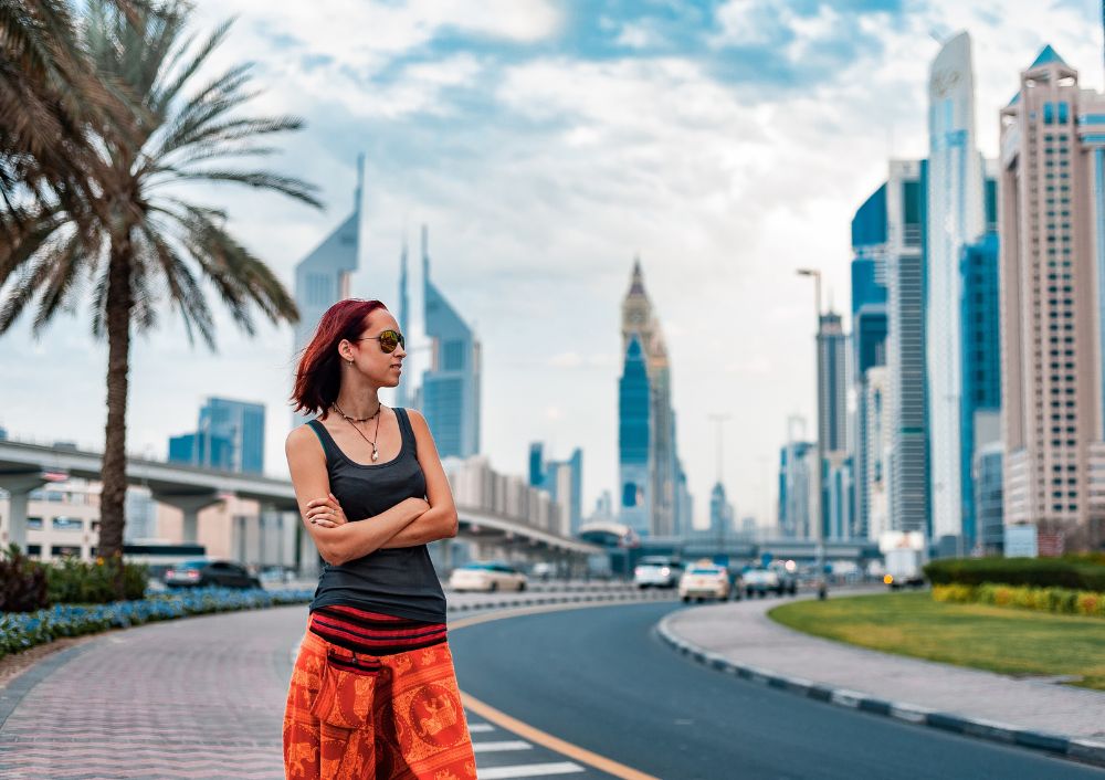 Woman traveler exploring modern skyscrapers in Dubai during a Dubai city tour package