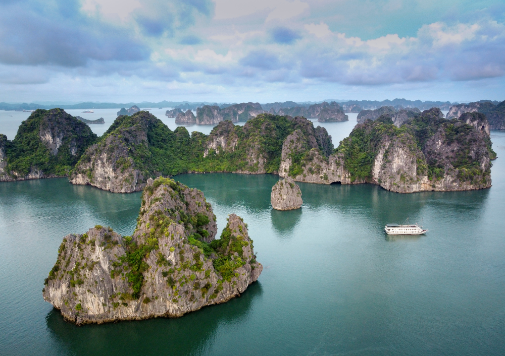 Aerial view of Halong Bay limestone islands and emerald waters, featured in the 9 Days & 8 Nights Vietnam Tour Package